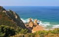 Picturesque rocks on a lonely beach of Atlantic ocean. Coast of Portugal, Cabo da Roca - the most western point of Europe